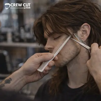 Barber shaping temple area to reduce bulk on middle part wolf cut men